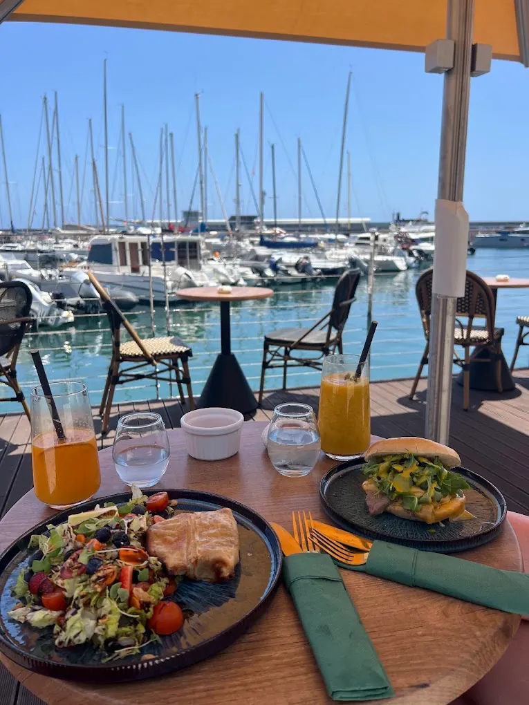 Brunch table with drinks and marina view at BrunchVille